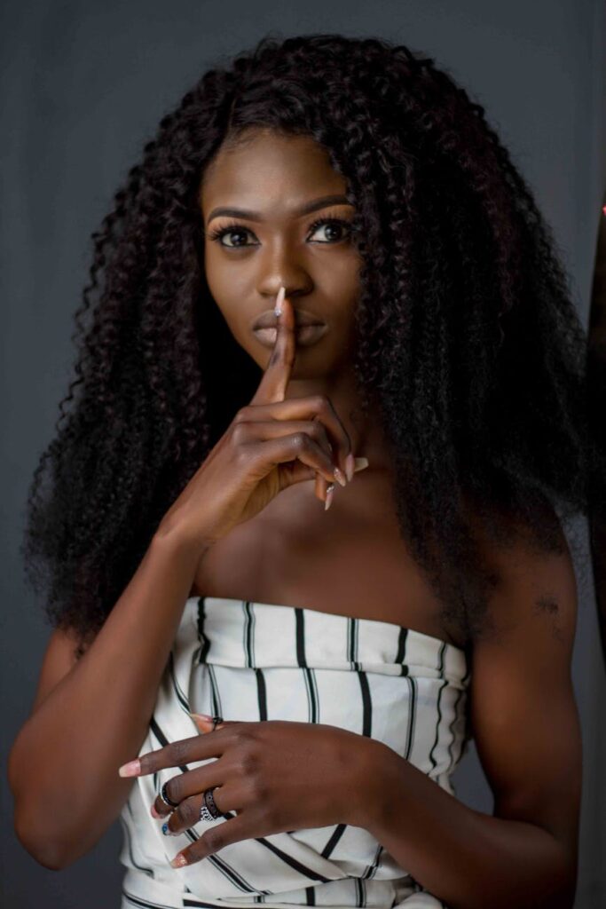 photo of woman putting her finger on her lips